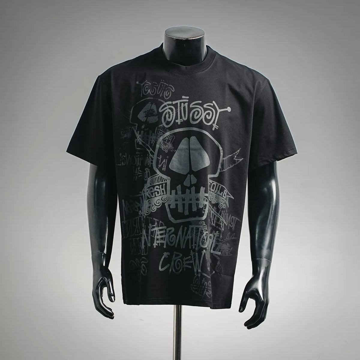 Stussy black graphic T-shirt with large skull and script-style print on front