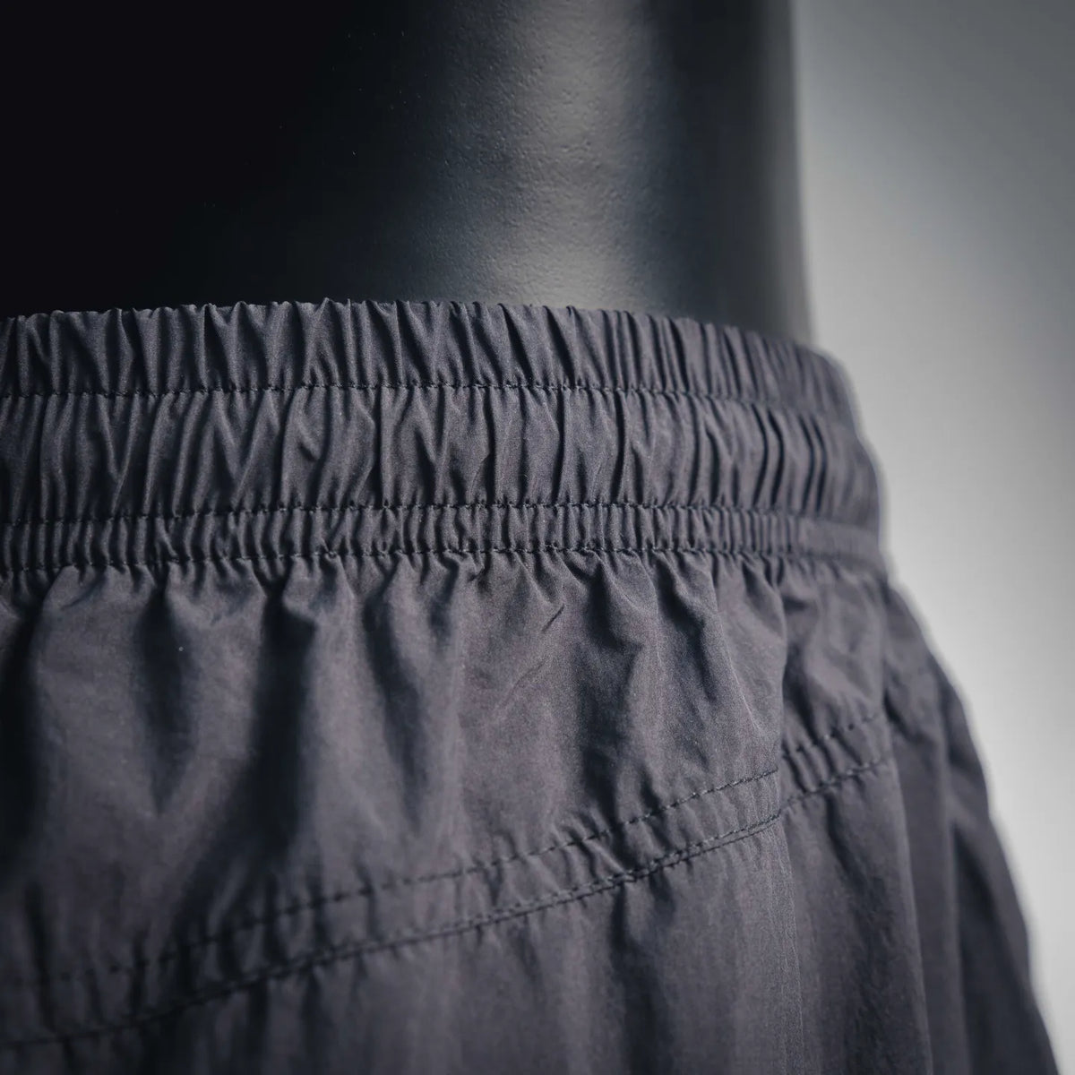 Stussy black shorts close-up of elastic waistband and gathered waist