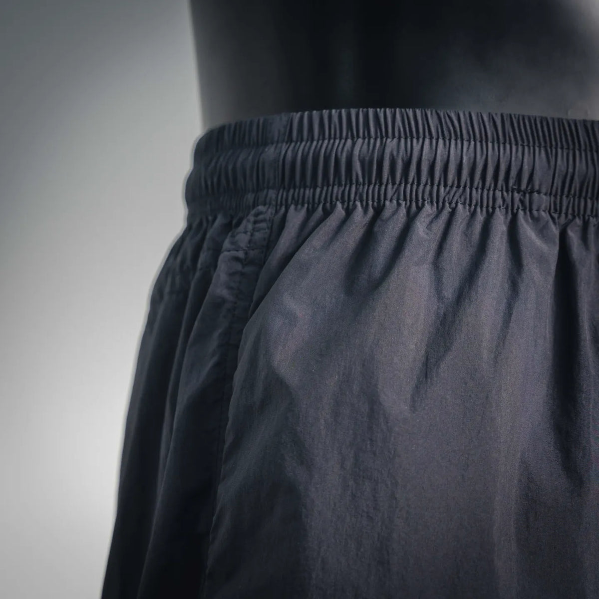 Stussy black shorts with wrinkle-textured fabric and elastic waistband