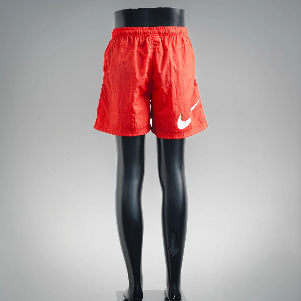 Red athletic shorts with elastic waistband and Nike swoosh on the right leg