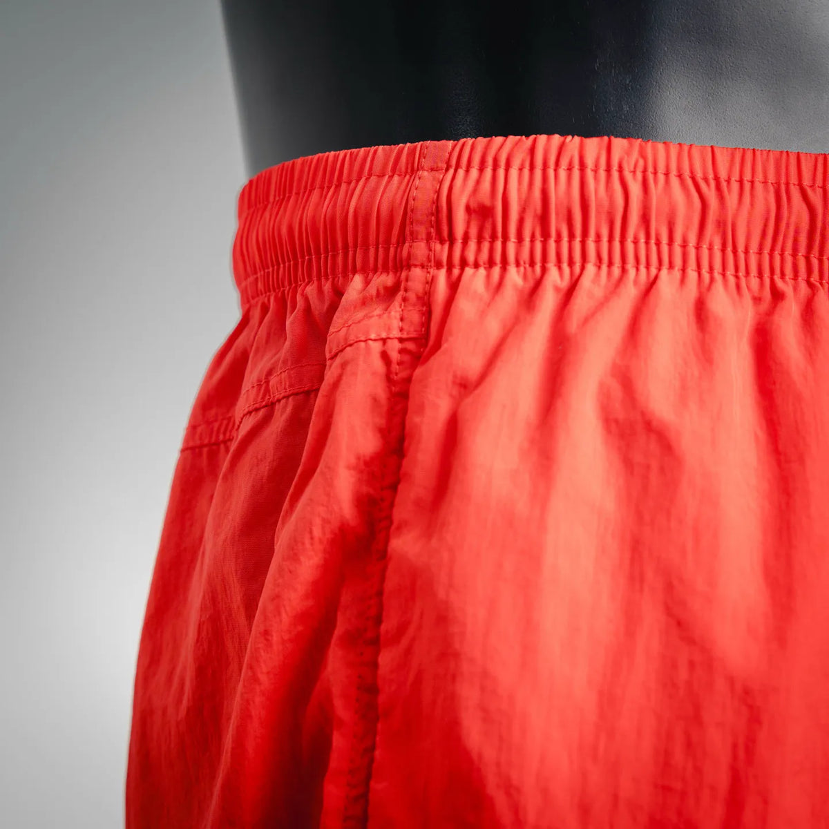 Red shorts with elastic waistband and stitched fly/side seam detail