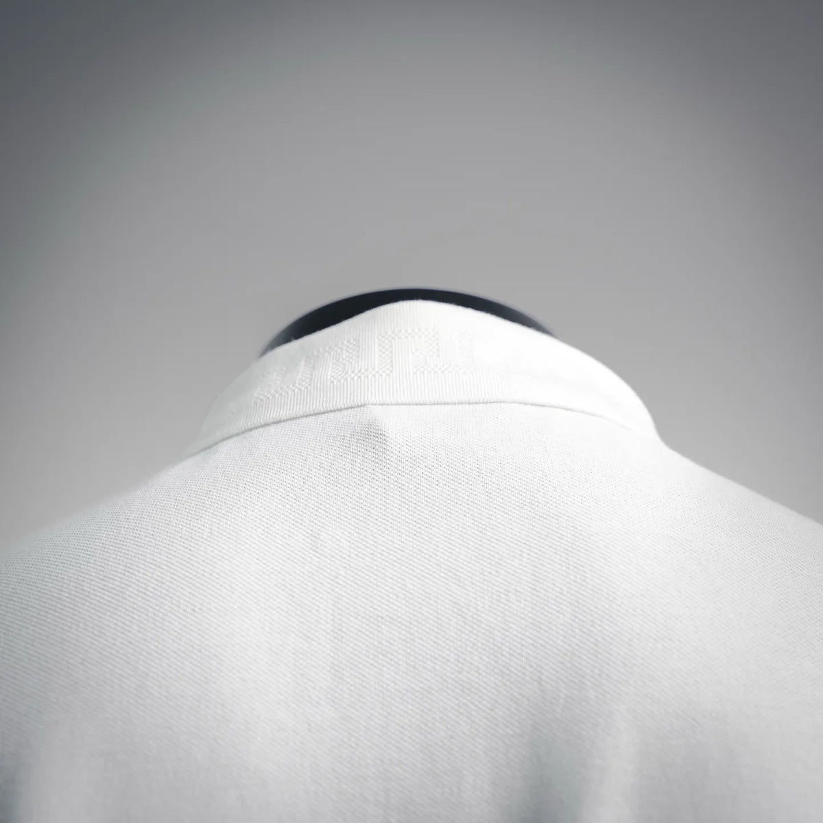 White polo shirt collar back with folded neckline and clean seam stitching