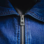Front metal zipper and stitched placket detail on denim jacket