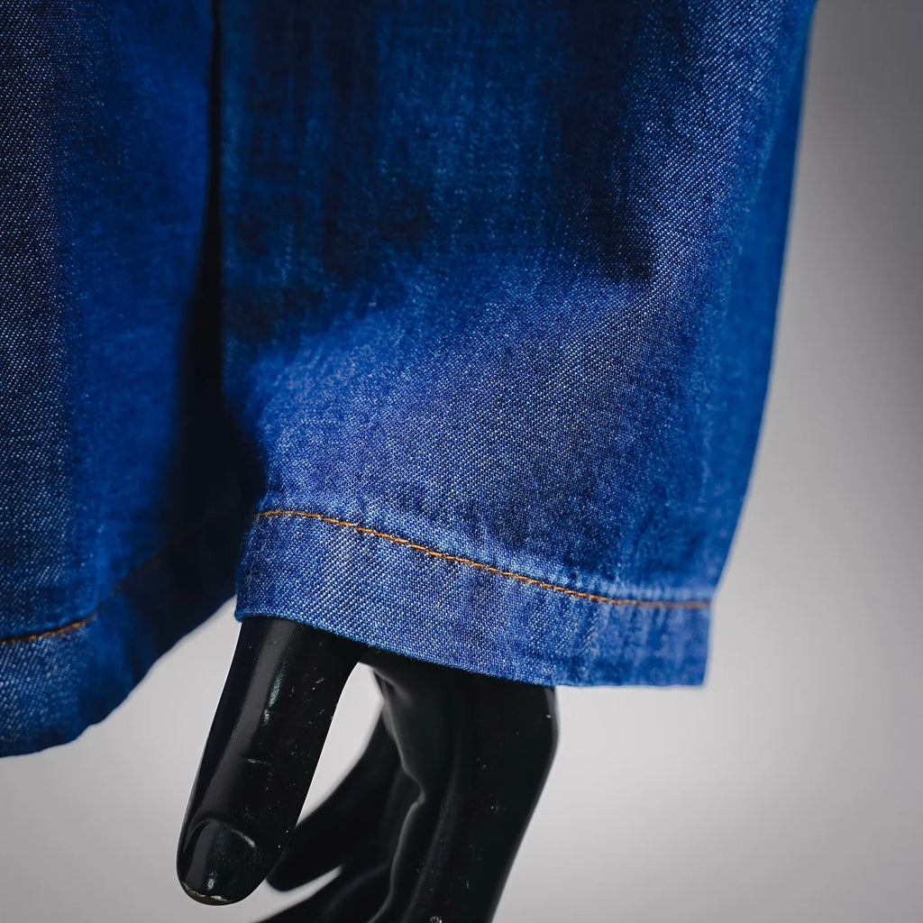 Denim jacket sleeve hem with orange stitch detail