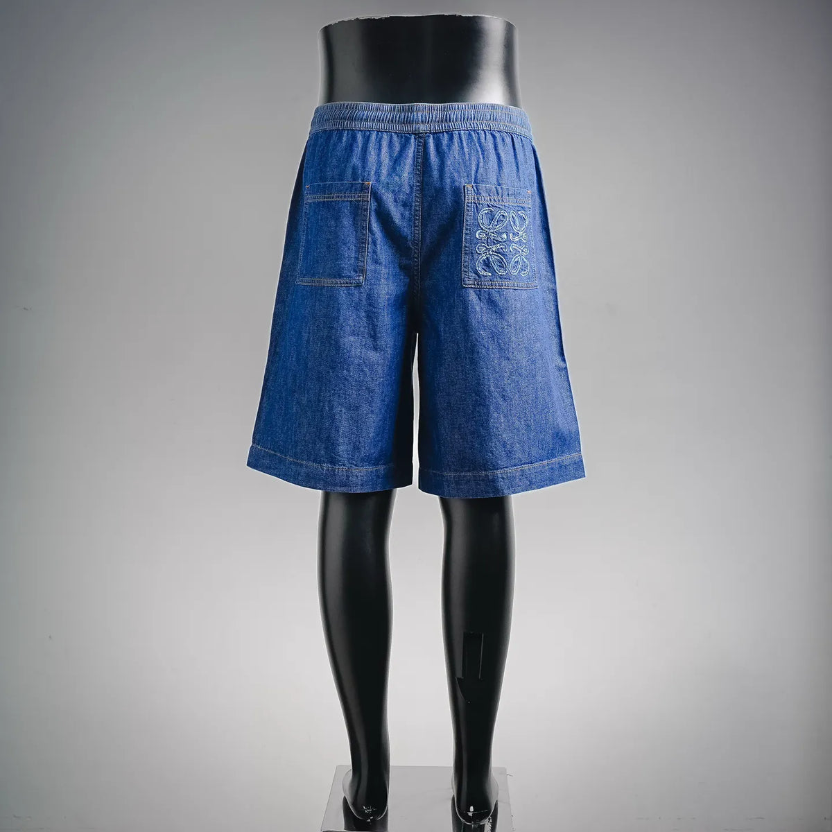 LOEWE blue denim shorts back view with embroidered logo and elastic waist