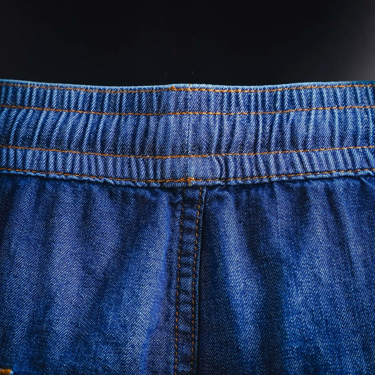 Blue denim shorts front with vertical seam and elastic waistband