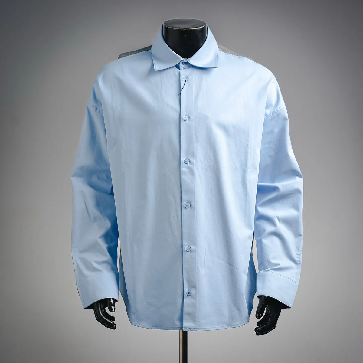 Light blue button-up dress shirt with pointed collar and front placket