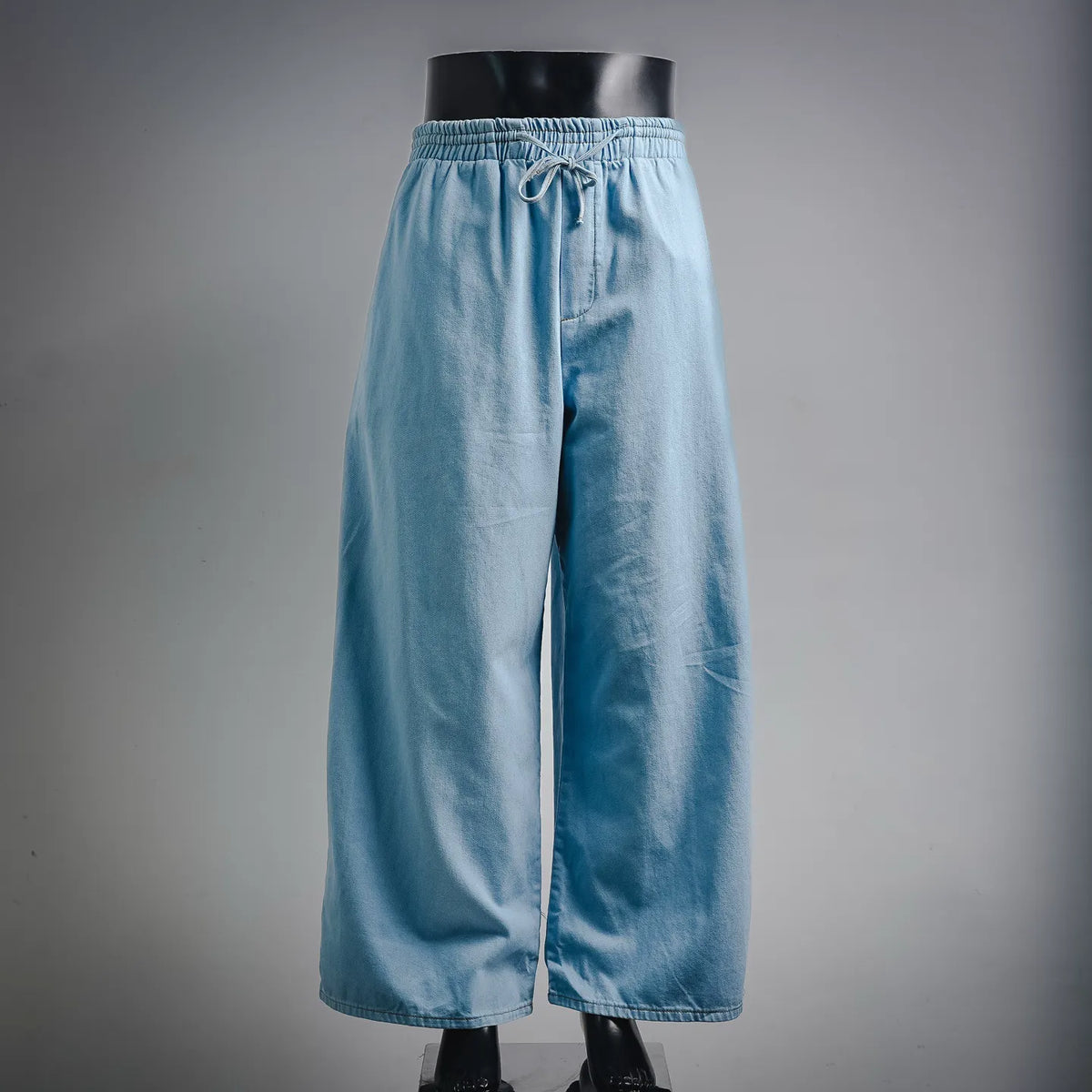 Light blue denim pants with elastic waistband and drawstring
