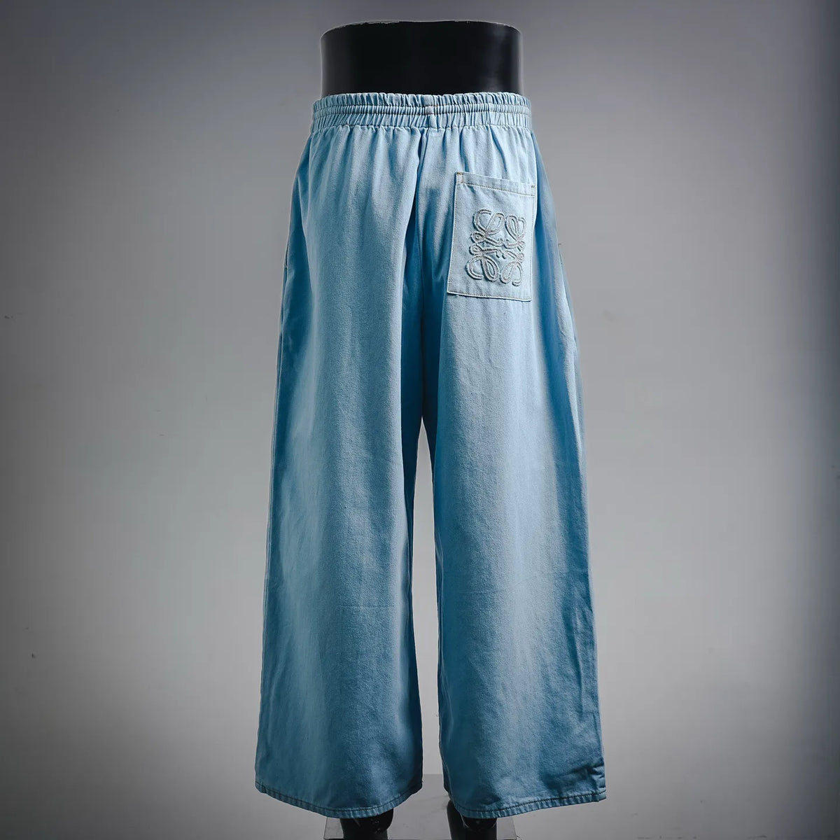 Light blue wide-leg denim pants with elastic waist and front patch