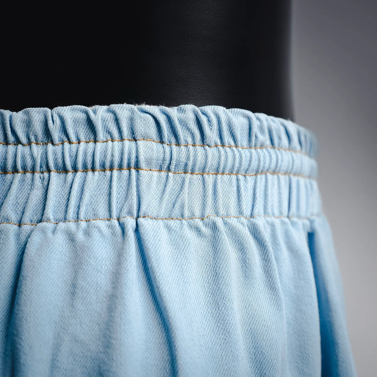 Light blue denim waistband with gathered elastic and contrast stitching