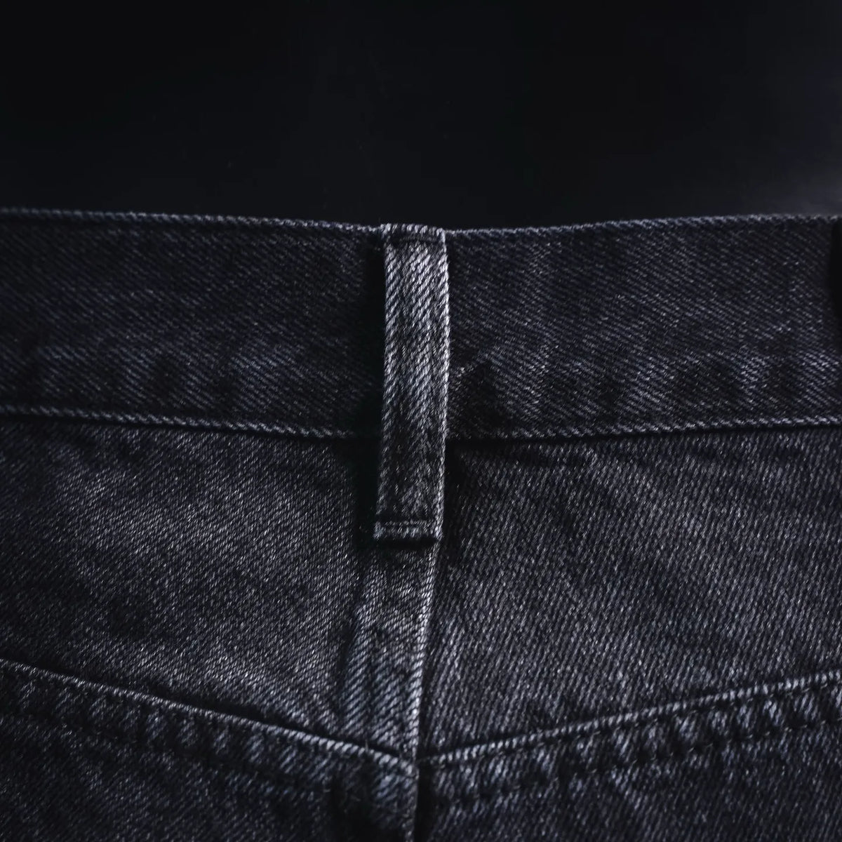 Denim waistband with stitched seam and button placket detail