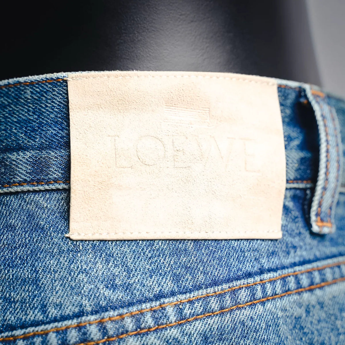 LOEWE denim pants beige interior label patch with embossed LOEWE text.