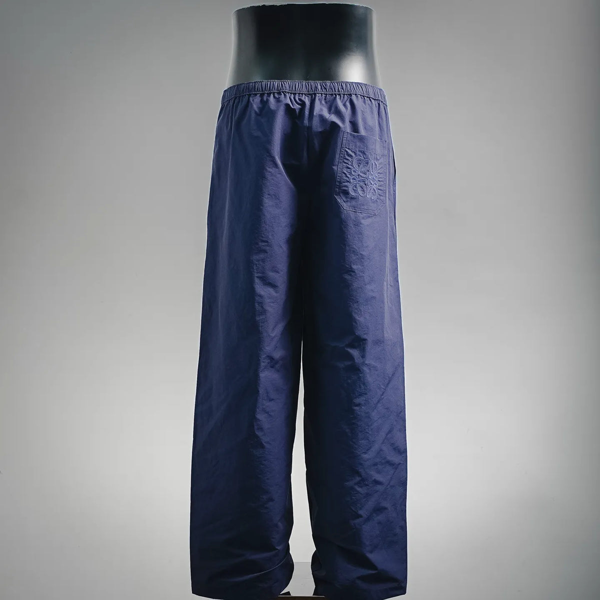 Dark blue drawstring pants with elastic waist and loose wide legs