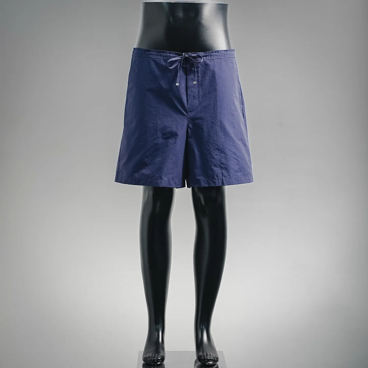 Dark blue drawstring shorts with elastic waistband and front pockets