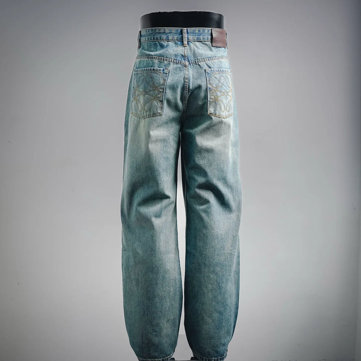 Light blue denim pants back view with stitched yoke and waistband