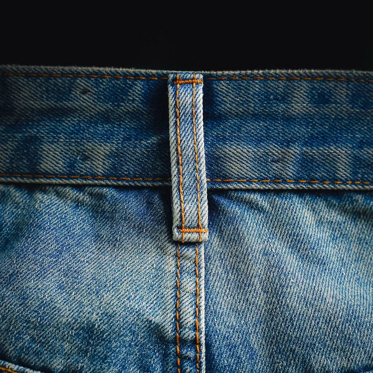 Denim button fly seam with reinforced stitching detail
