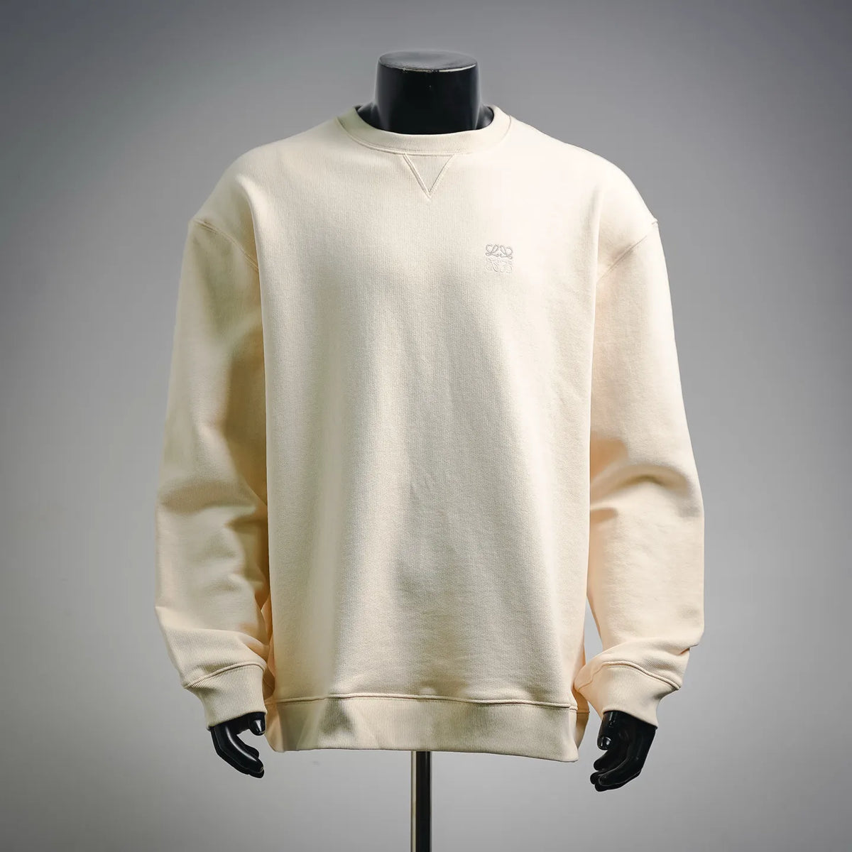 LOEWE long-sleeve crewneck sweatshirt in light cream, ribbed cuffs and small chest logo