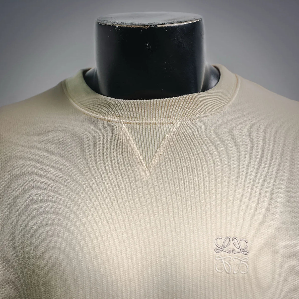 LOEWE crewneck sweatshirt neckline close-up with ribbed collar and small embroidered logo