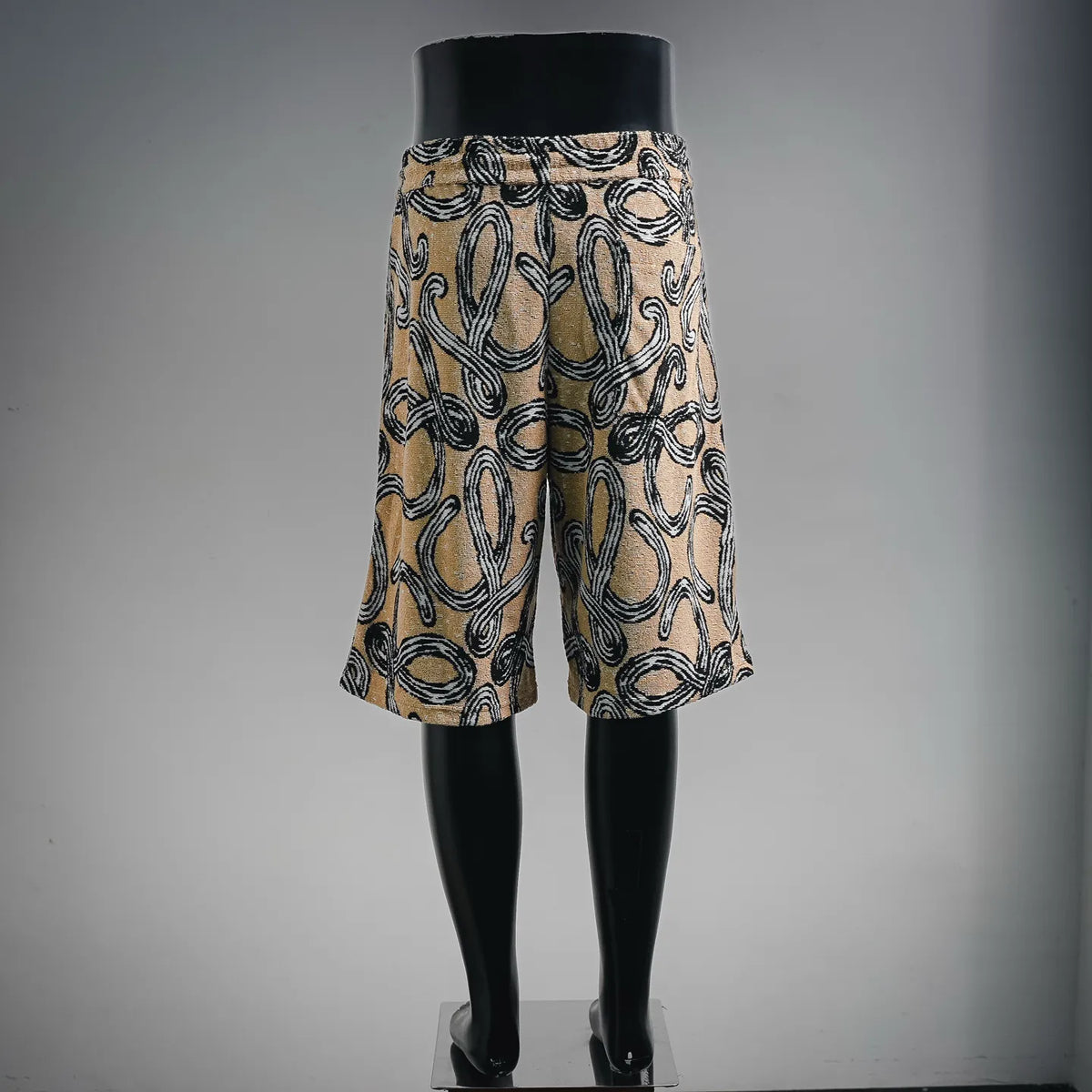 Tan and black patterned drawstring shorts, full front view
