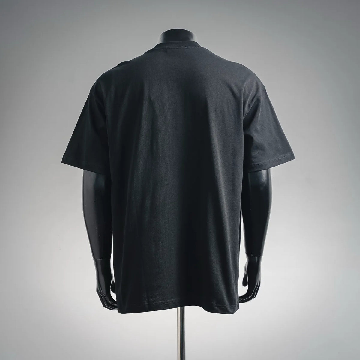 Black T-shirt with plain back and short sleeves on a mannequin
