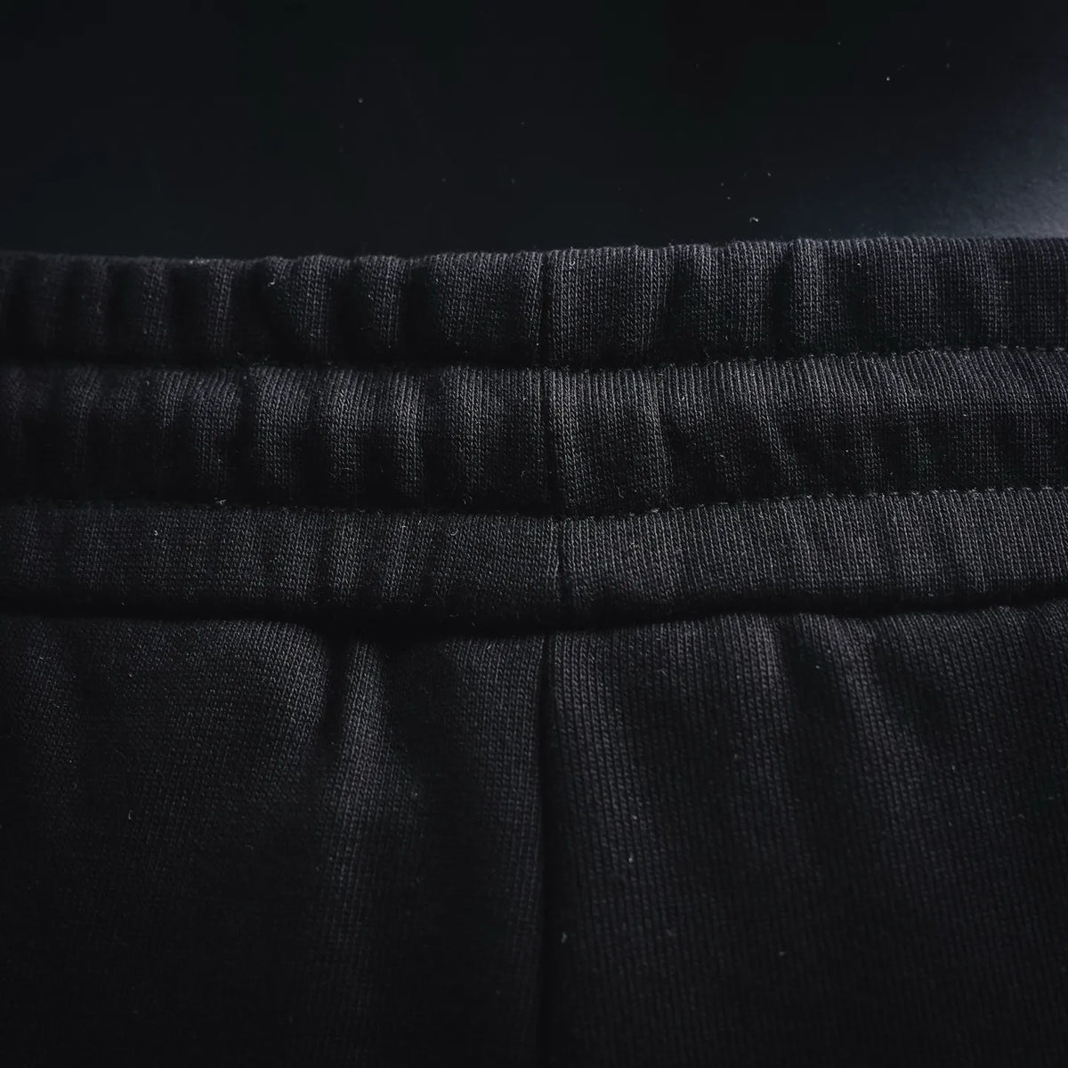 LOEWE black drawstring shorts waistband close-up with gathered elastic