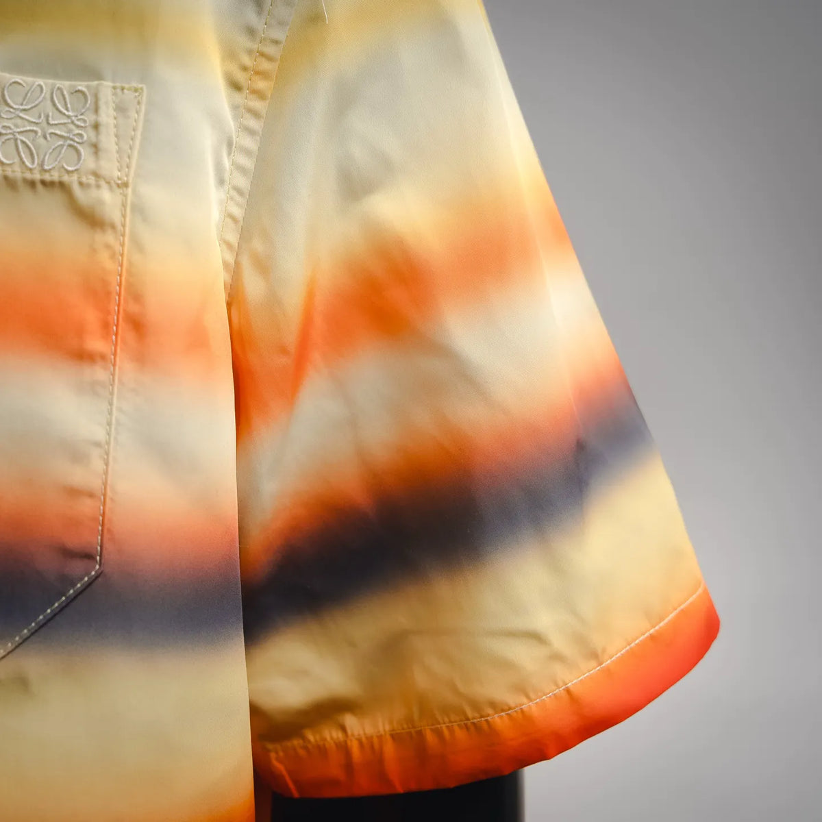 Sleeve and side seam of striped short-sleeve button-up shirt