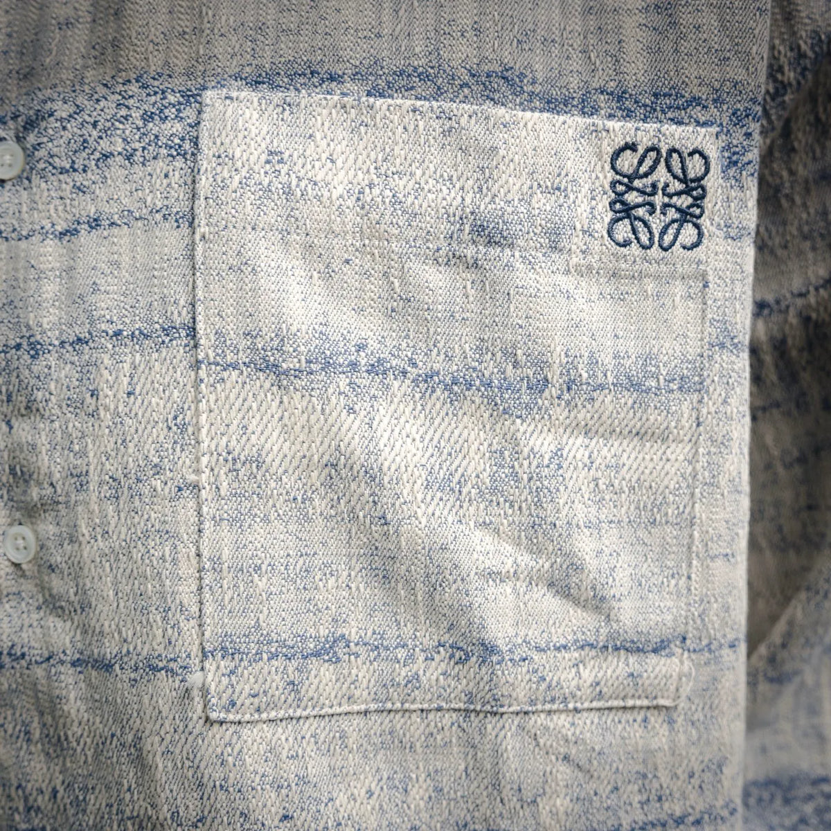 Long-sleeve button-up shirt with chest patch logo in light blue and white plaid