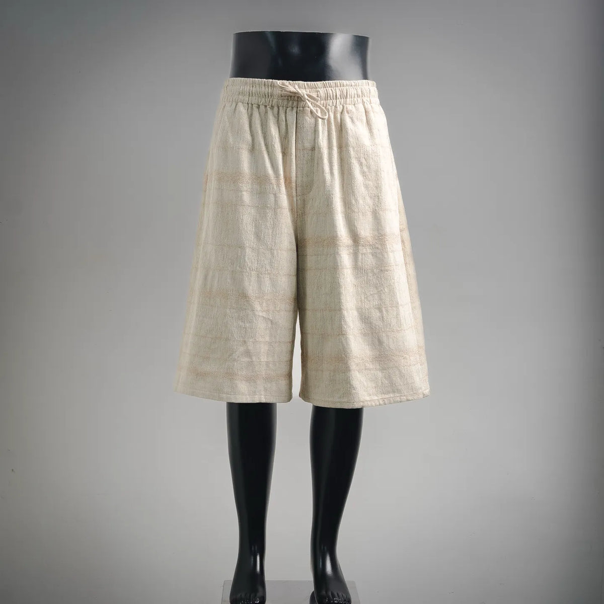Cream linen shorts with elastic waistband and relaxed wide legs