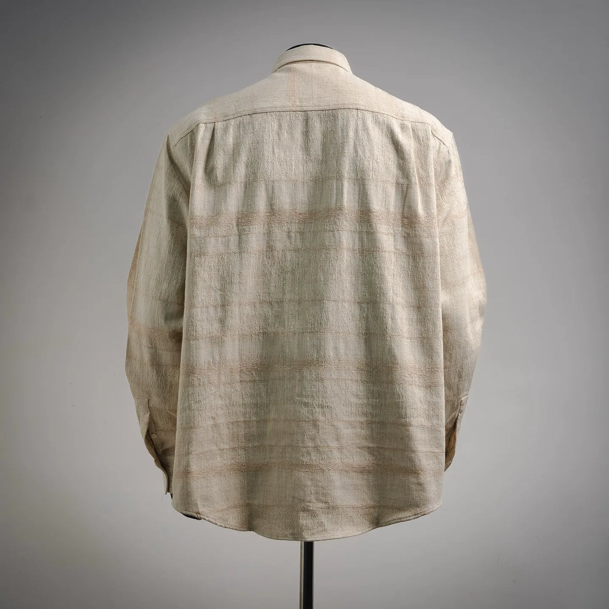 Beige long-sleeve button-up shirt, back view with collar and button placket.