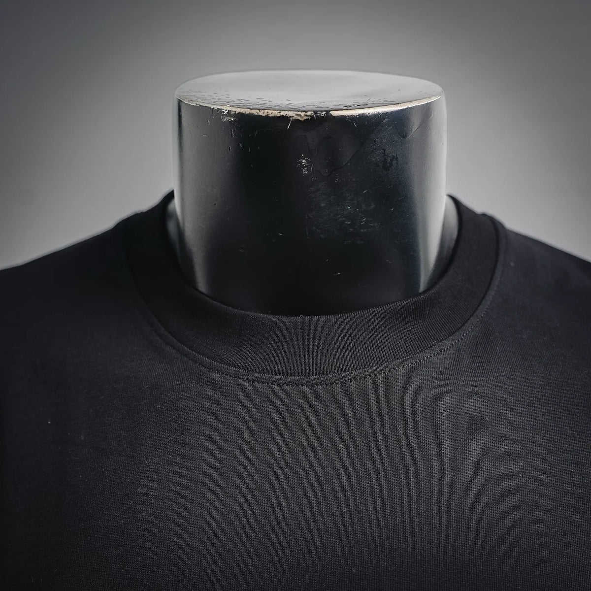 Black crew-neck t-shirt neckline close-up