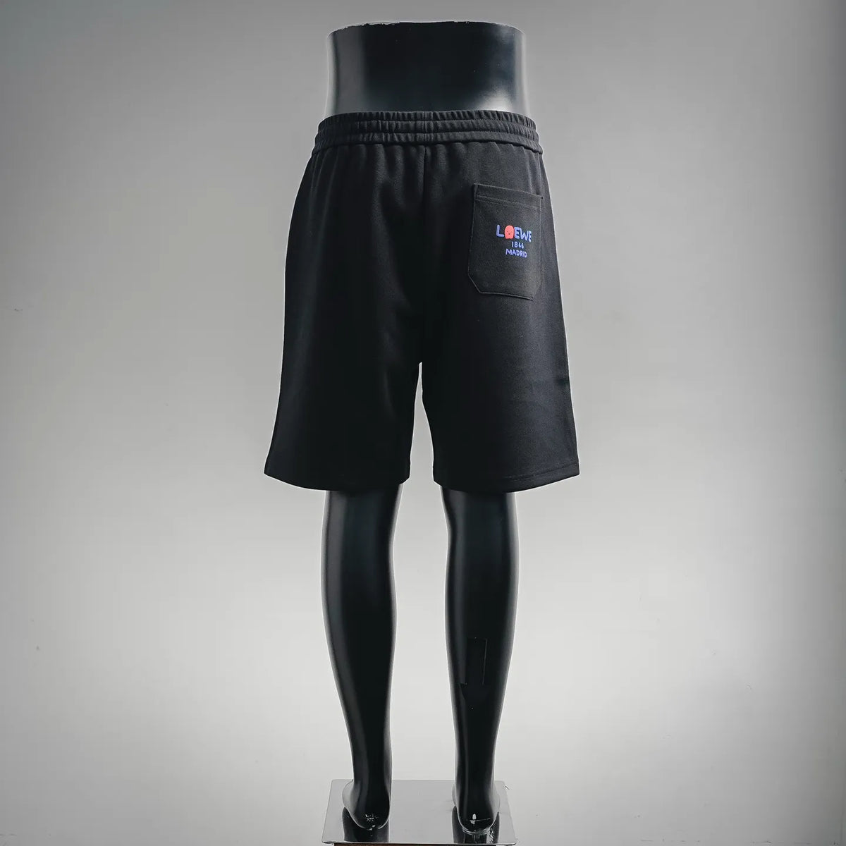 Black LOEWE shorts with logo patch on back pocket and elastic waistband