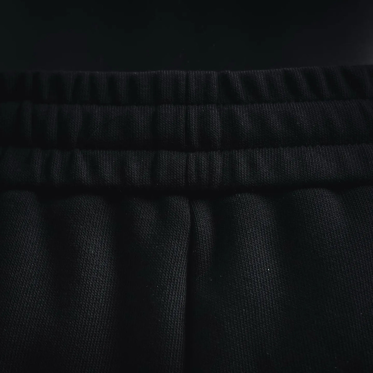 Black shorts waistband with stitched elastic trim