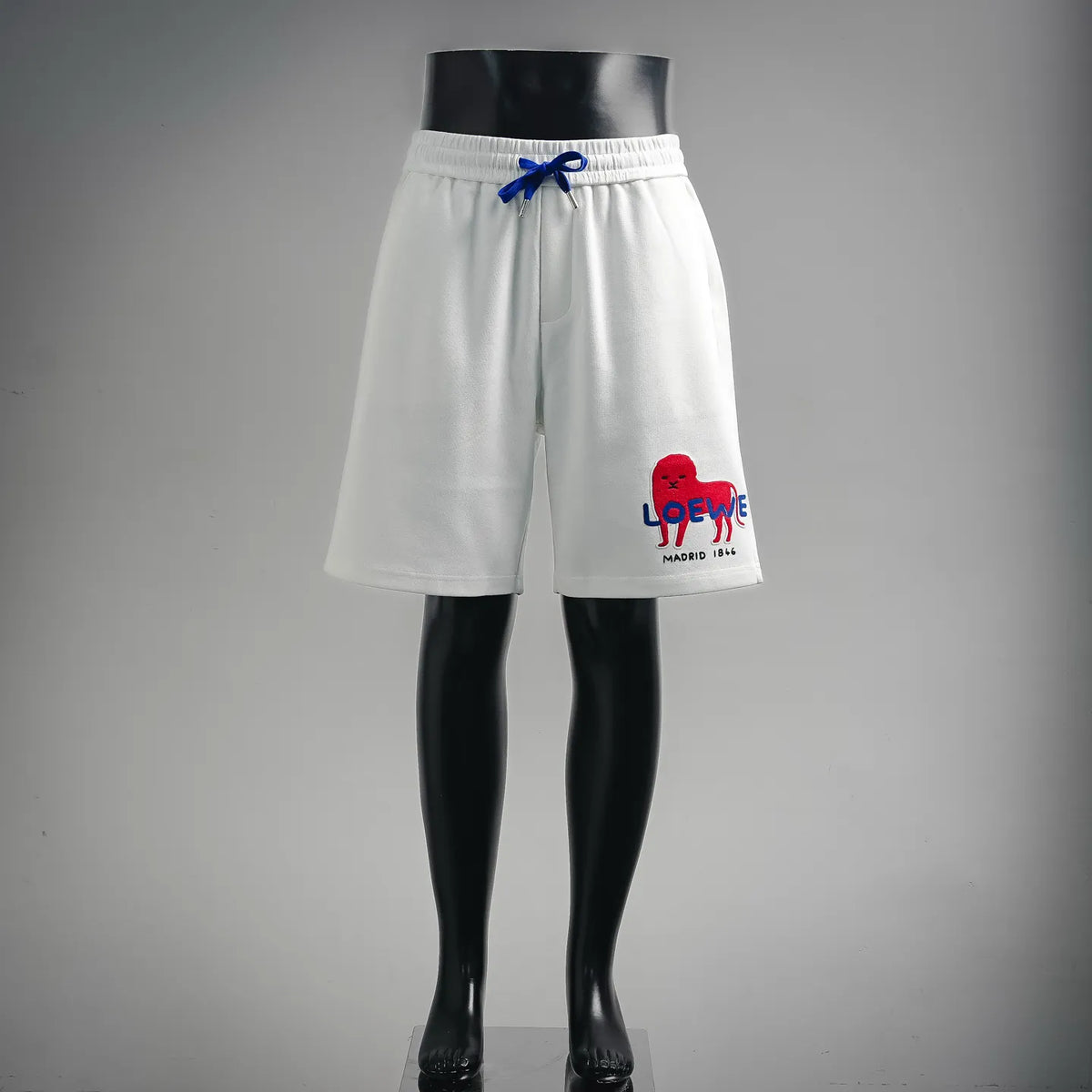 White LOEWE shorts with blue drawstring and red animal logo on front