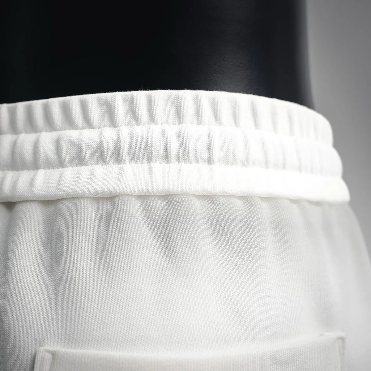 White shorts waistband with elastic and stitched panel detail