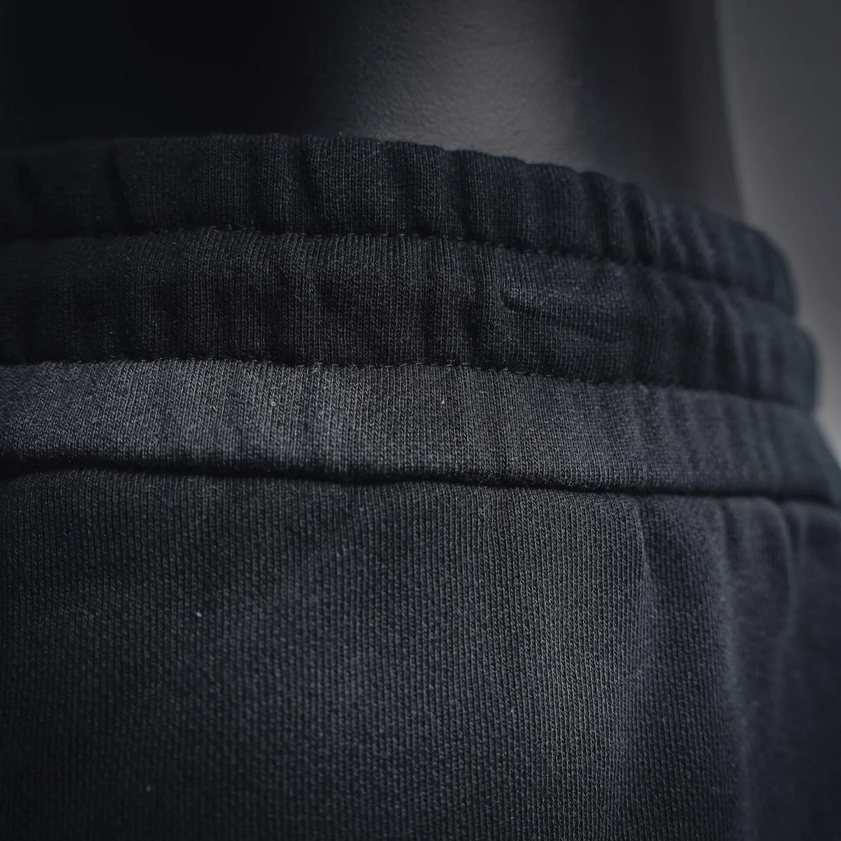 Black shorts waistband with elastic ruching and stitched seam