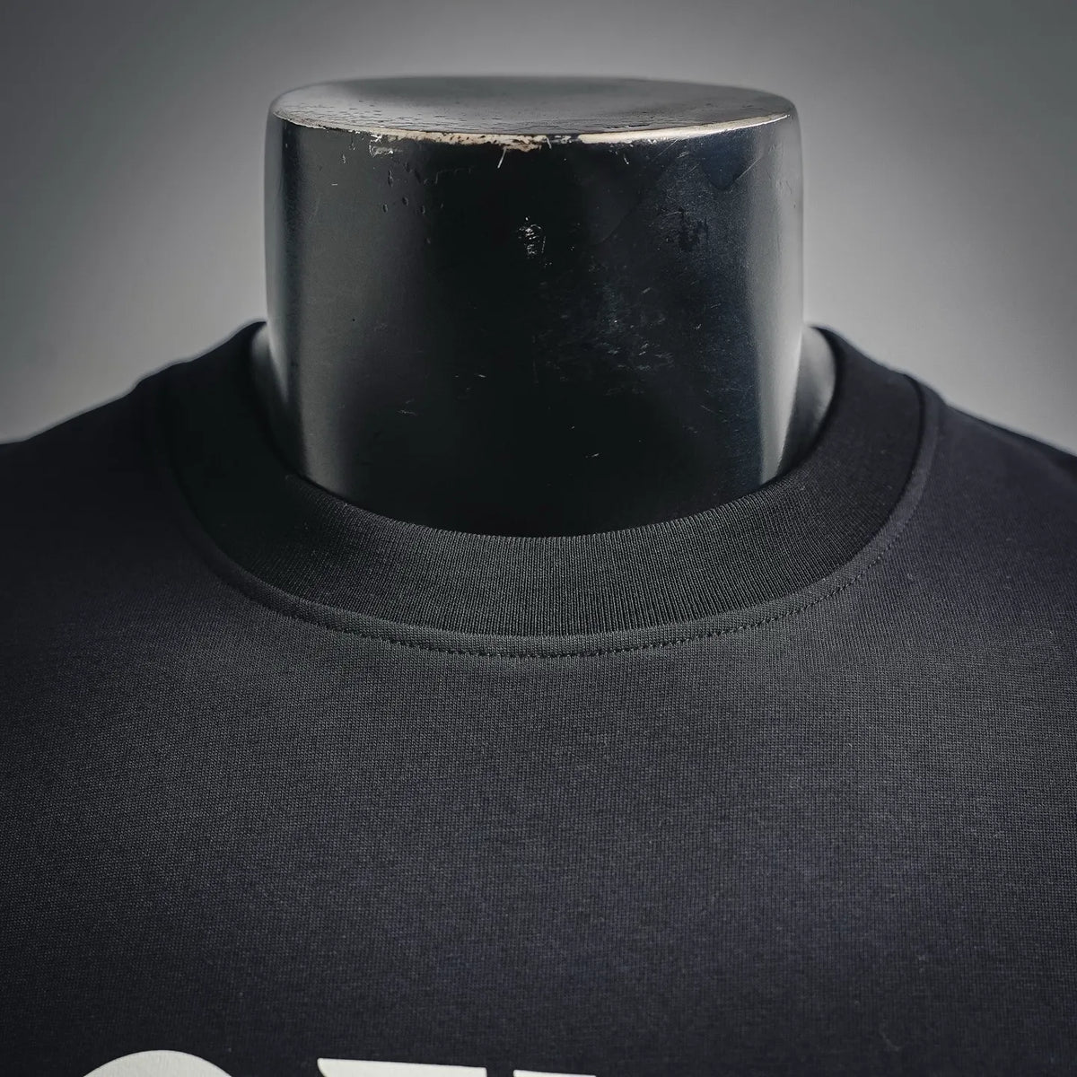 Close-up of crew neck collar on dark T-shirt