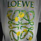 White LOEWE T-shirt with large green and yellow floral logo print.