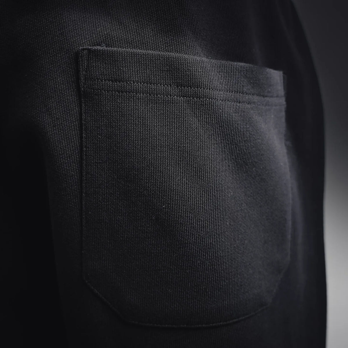 Black shorts-style pants pocket with stitched side seam