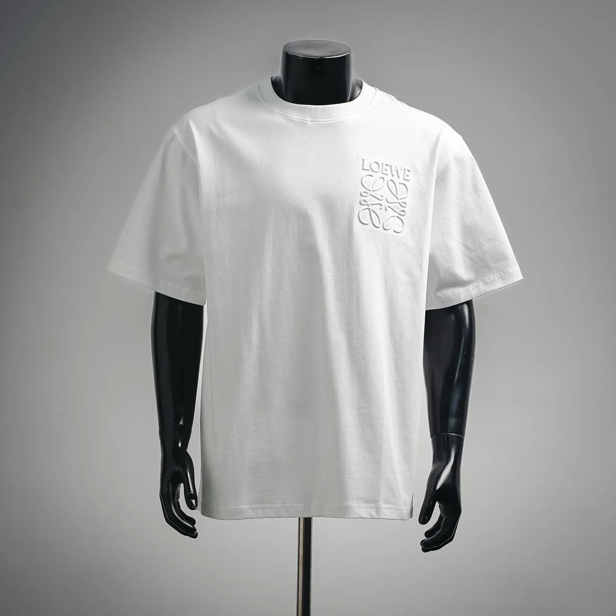 White crew-neck short-sleeve T-shirt with LOEWE logo on the chest.