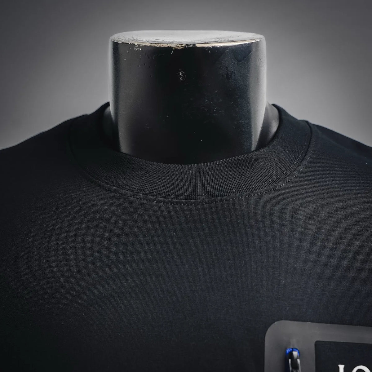 Black crew-neck T-shirt collar close-up