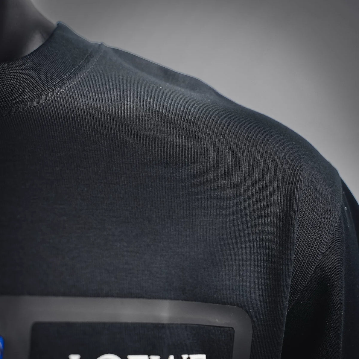 Black T-shirt fabric and side seam close-up