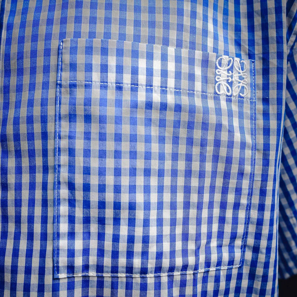 Blue and white gingham shirt back yoke with decorative stitching