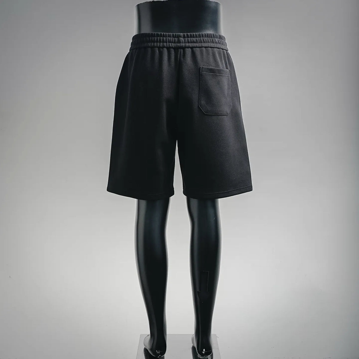 Black drawstring shorts with side pocket and elastic waistband