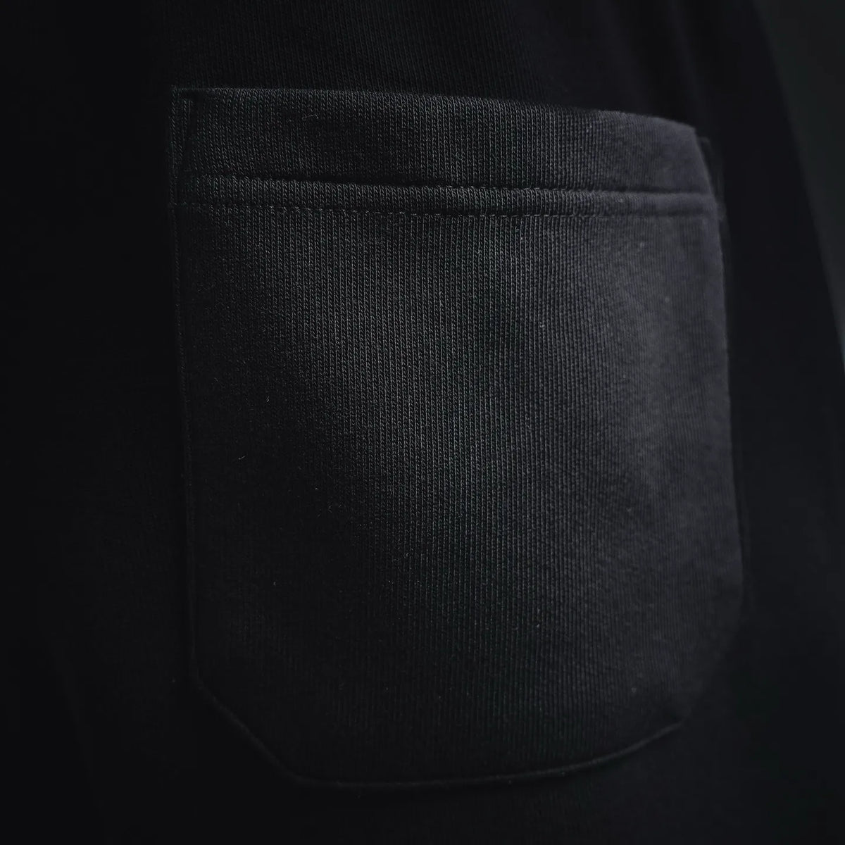 Black shorts featuring a single side pocket opening