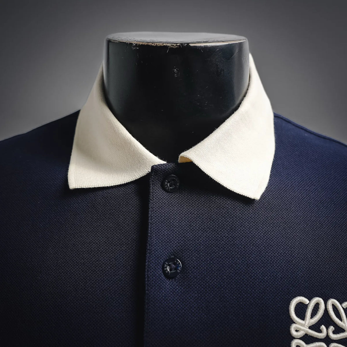 Navy LOEWE polo shirt with white collar and dark buttons