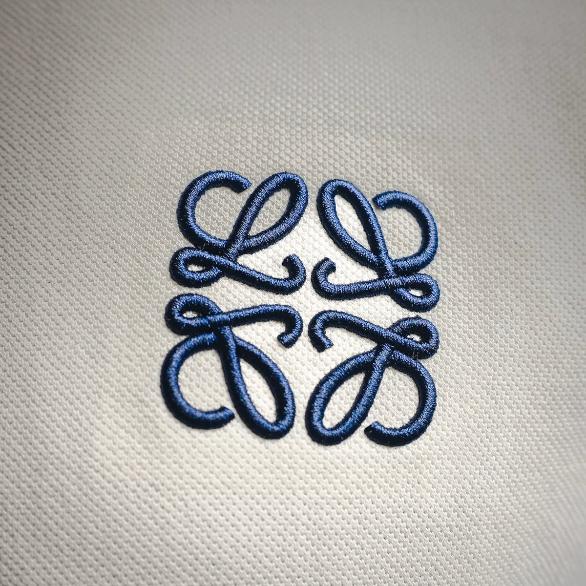 LOEWE polo shirt logo embroidery in blue on textured white fabric