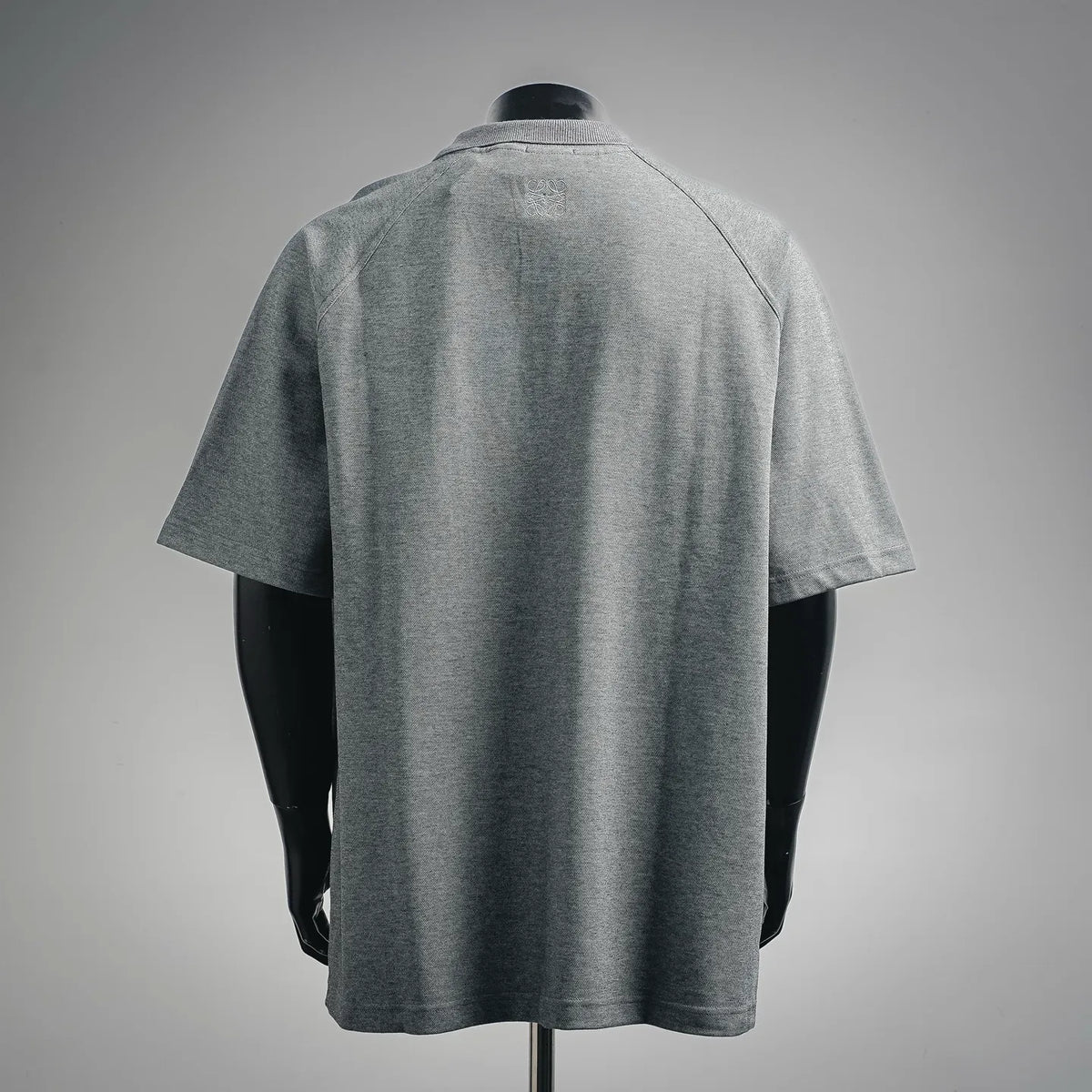 Back view of heather gray short-sleeve polo shirt with smooth shoulders