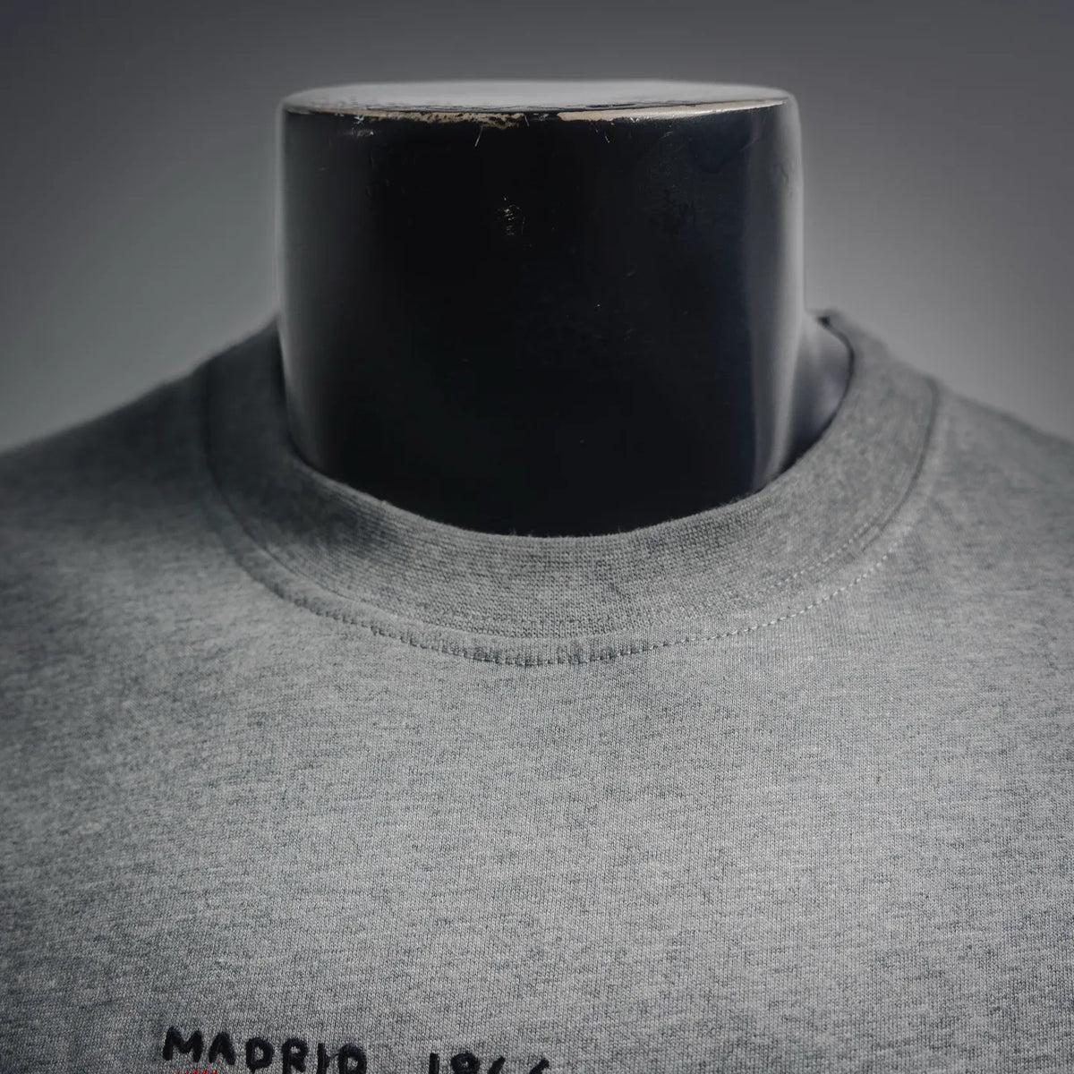 Heather gray T-shirt crew neck with black text detail near collar