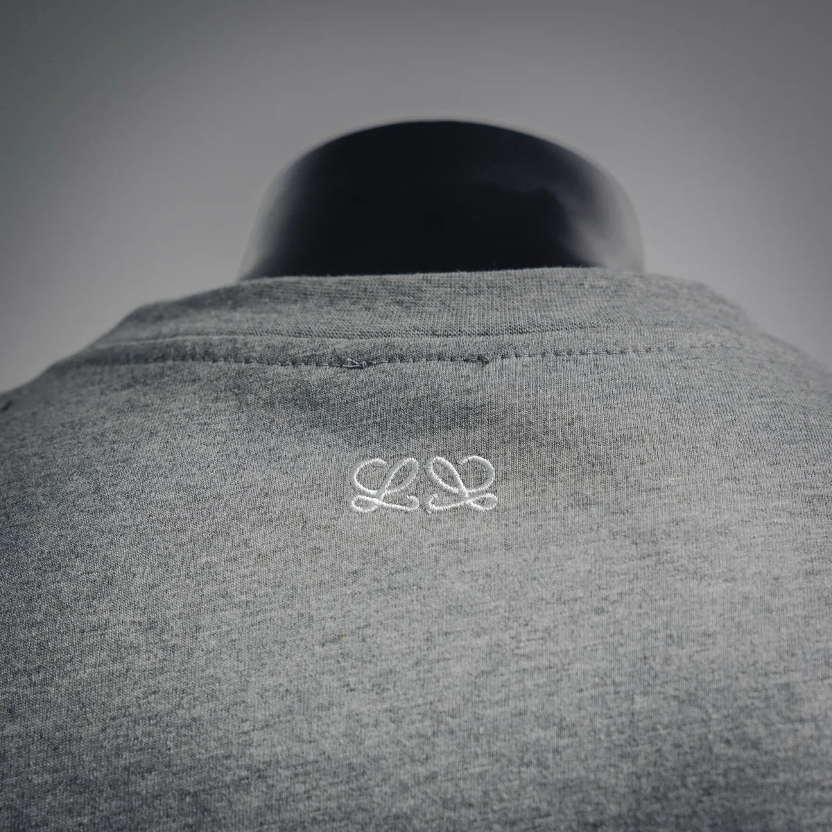 Heather gray T-shirt with small white back logo near upper center