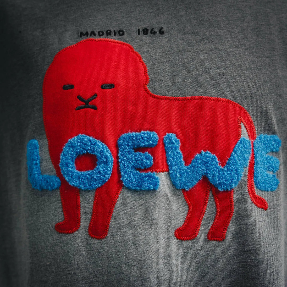 Heather gray T-shirt with close-up red animal graphic and large blue text